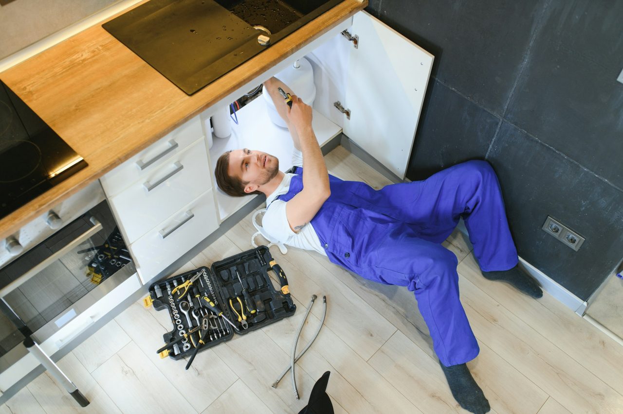 young-plumber-or-technician-installing-or-repairing-system-of-water-filtration.jpg